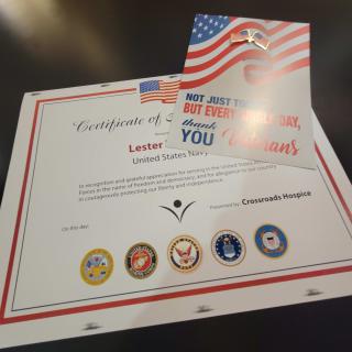A certificate of appreciation featuring the American flag and military seals.