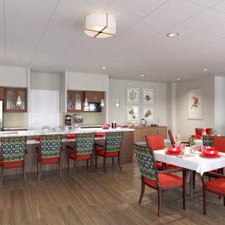 A modern kitchen and dining area featuring a sleek design with red chairs and bar stools, wood flooring, and an open layout.