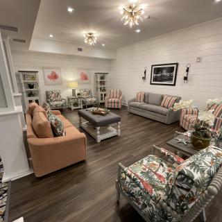 A cozy and beautifully decorated living room featuring modern lighting and a comfortable seating area.