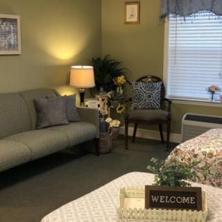 A cozy living room with a sofa, lamp, and welcoming decor.