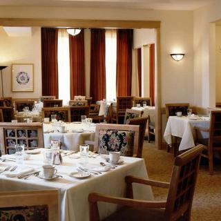 An elegant restaurant dining area with neatly arranged tables and chairs, ready for guests.