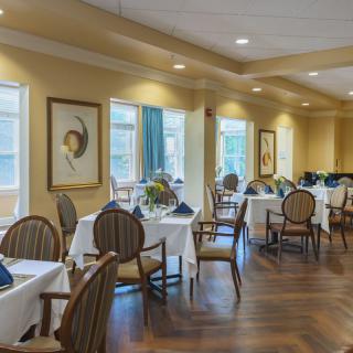A well-appointed dining area with elegantly set tables and comfortable seating.