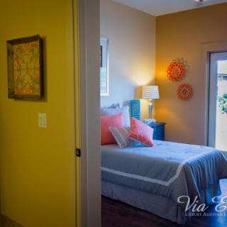 A cozy and colorful bedroom showcasing modern decor and inviting natural light.