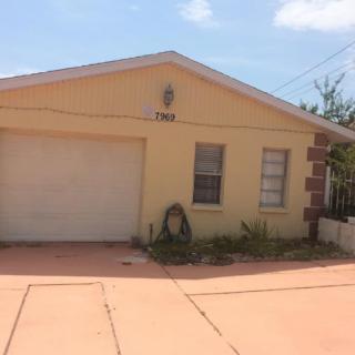 A single-story house with a yellow exterior and an attached garage.