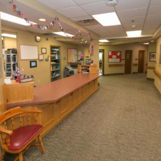 A spacious reception area with a desk and chairs, decorated for the season.