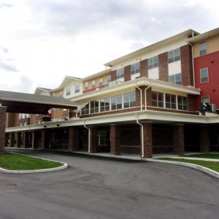 A modern hotel building with multiple floors and a covered entrance.