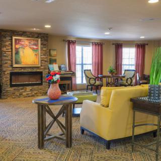 A cozy living room with comfortable seating and a fireplace.