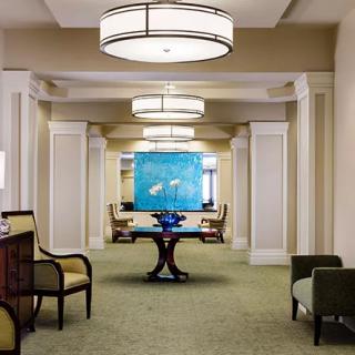 A well-lit hallway with elegant furniture and artwork.