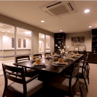 A modern and elegantly decorated dining room with a set table ready for guests.