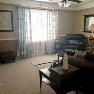 A cozy living room with comfortable furniture and natural light.