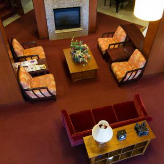 A cozy living room setup featuring comfortable seating and a welcoming fireplace.