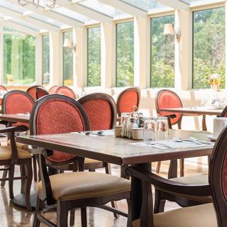 A bright and airy restaurant dining area with elegant tables and chairs.