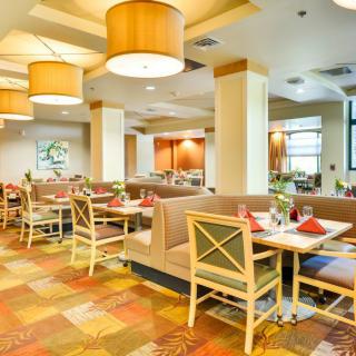 A modern restaurant interior with neatly arranged tables and comfortable seating.