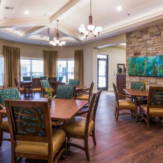 A modern dining area with elegant furnishings and warm lighting.