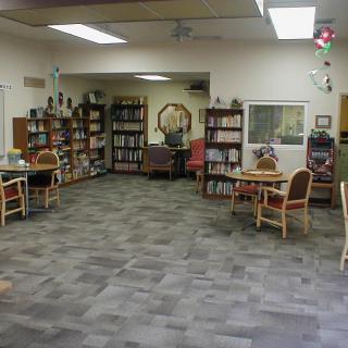 A cozy library space with bookshelves and seating.