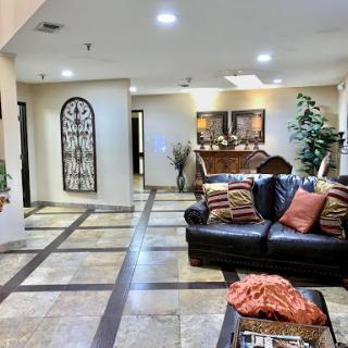 A cozy living room featuring a leather couch and decorative elements.