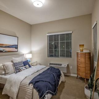 A modern, minimalist bedroom with neutral colors and simple decor.