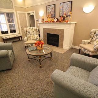 A cozy living room with comfortable armchairs and a decorated fireplace.