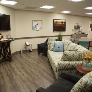 A cozy waiting room with comfortable seating and modern decor.