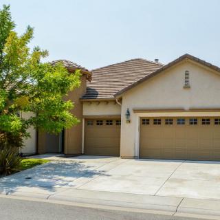 A suburban house with a two-car garage and a driveway.