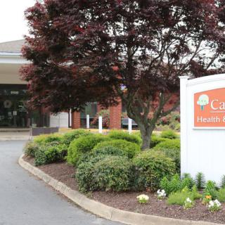 Entrance to a healthcare facility with prominent signage and landscaping.