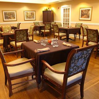 An elegant dining area with neatly arranged tables and chairs.