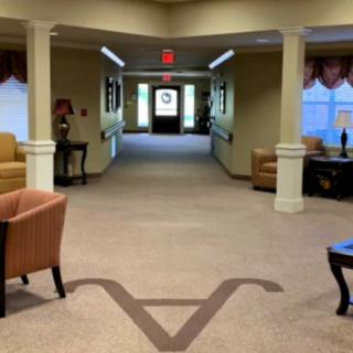 A well-lit hallway with seating arrangements and decorative elements.