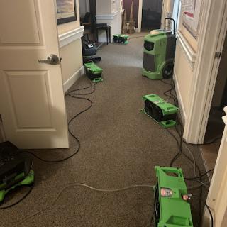 Equipment set up in a hallway for water damage restoration.