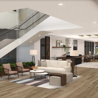 A modern lobby with stylish furniture and a staircase.