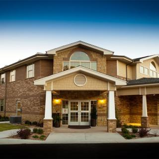 A two-story brick building with a prominent entrance.