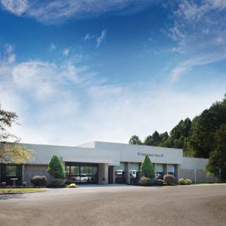 A modern commercial building set against a clear blue sky.