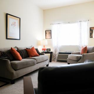 A cozy living room with comfortable sofas and warm lighting.