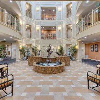 Spacious atrium lobby with a central fountain and surrounding balconies.