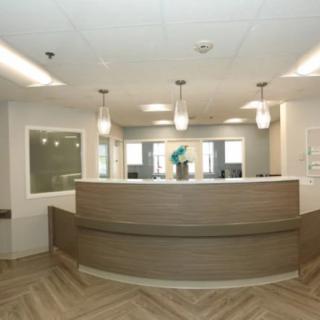 A modern reception desk in an office setting with stylish lighting and decor.