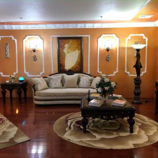 A traditional living room with ornate decorations and warm lighting.