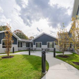 A modern residential area with a landscaped courtyard and pathway.