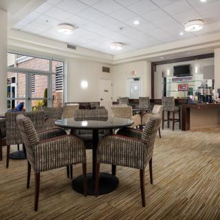 A modern lounge area with comfortable seating and a bar.