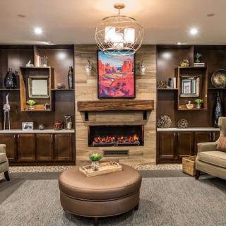 A cozy, modern living room with a central fireplace and stylish decor.