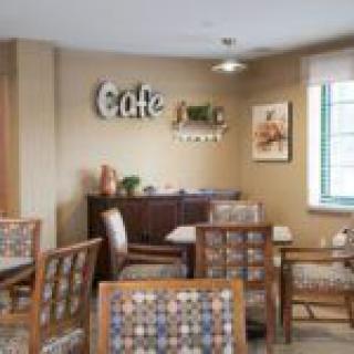 A cozy cafe interior with tables and chairs arranged for seating.