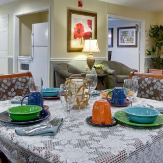 A cozy dining area with a beautifully set table featuring colorful dishes and elegant decor.
