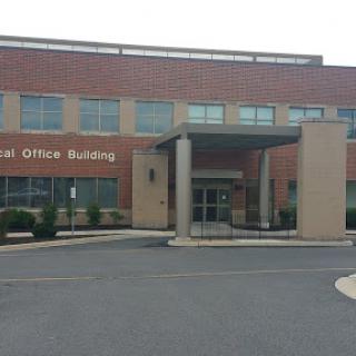 A view of a modern office building with a prominent entrance.