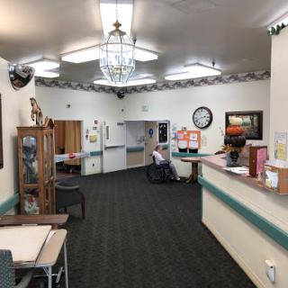 A welcoming lobby area featuring a reception desk, seating, and decorative elements.