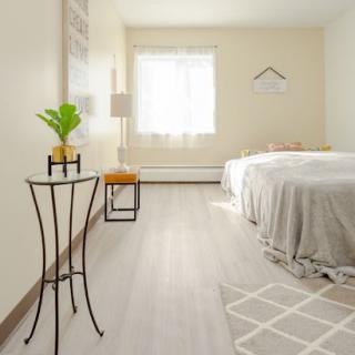 A serene and minimalist bedroom, featuring natural light and simple decor.