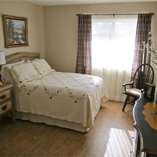 Cozy bedroom with classic decor and natural light.