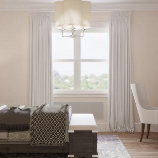 A modern living room with elegant curtains, a central window, cozy seating, and a stylish chandelier.