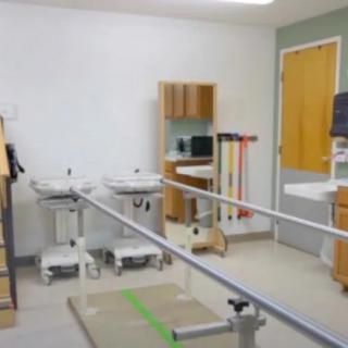 A rehabilitation clinic featuring parallel bars for physical therapy exercises.