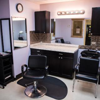 A well-equipped hair salon featuring a stylish setup for haircuts and styling.