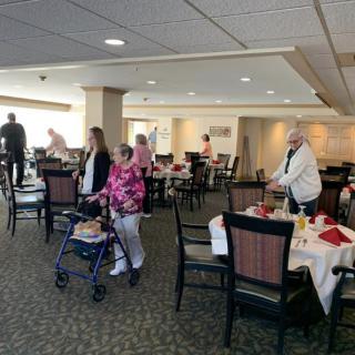 Seniors socializing in a dining room setting.