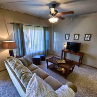 A cozy living room with a comfortable sofa, television, and warm lighting.