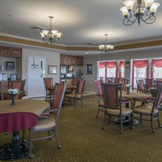 A cozy dining area with multiple tables and elegant lighting.
